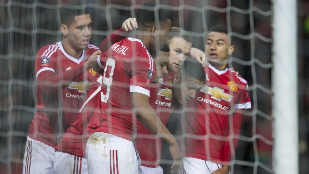Net gain: Manchester United's Wayne Rooney celebrates with teammates.