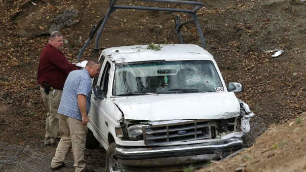 Investigators view a pickup truck involved in a deadly shooting at the Rancho Tehama Reserve.