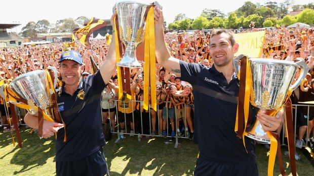 Can they go again? Hawthorn coach  Alastair Clarkson and captain Luke Hodge with the 2013, 2014 and 2015 premiership trophies.