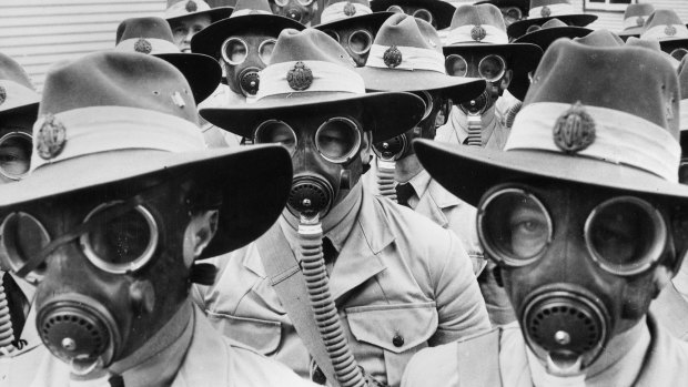 Australian soldiers sport gas masks in World War II.