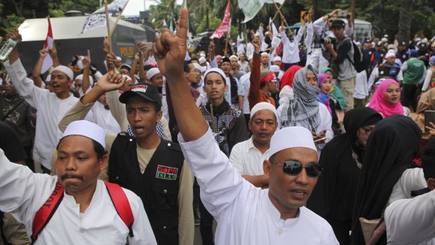 Indonesian Muslims demonstrate outside the court where Jakarta Governor Basuki Tjahaja Purnama, also known as Ahok, is facing blasphemy charges.