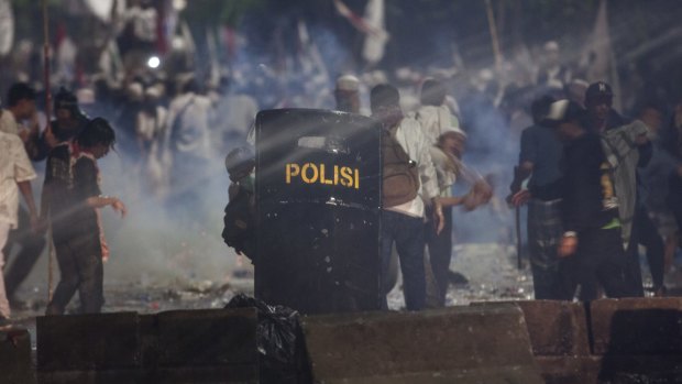 Police fire tear gas on protesters in Jakarta last month.