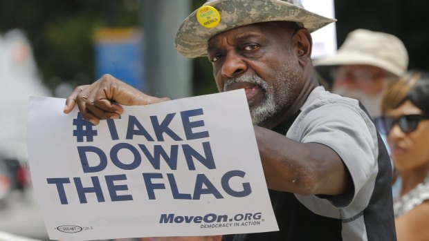 A protester against the Confederate flag, Theron Foster, of Columbia, gives a clear message outside the South Carolina state house.