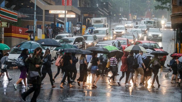 Rainfall brought by ex-cyclone Debbie smashes the Brisbane CBD.