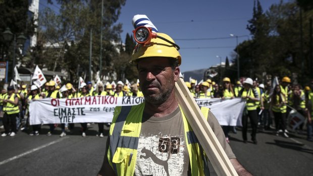 Miners march to the parliament during a rally in Athens on Thursday. 