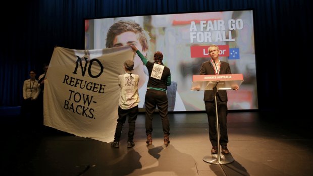 Protesters disrupt the debate on Labor's asylum seeker policies.