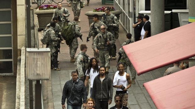 National Guard troopers and civilians in Baltimore's harbour area.