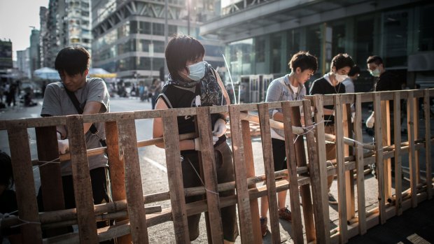 Going nowhere: Pro-democracy protesters reinforce a barricade in the Mong Kok district of Hong Kong.