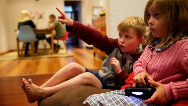 Engaged: Liam Hunter, 9 and Eve Hunter, 6, play Minecraft at their Leichhardt home.