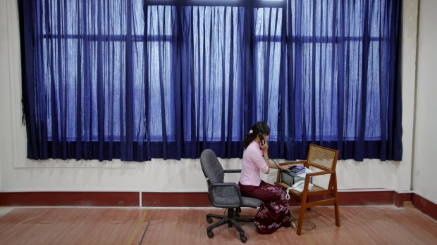 An employee speaks on a phone in a room for daily foreign exchange auctions at Myanmar's central bank in Yangon in 2012.