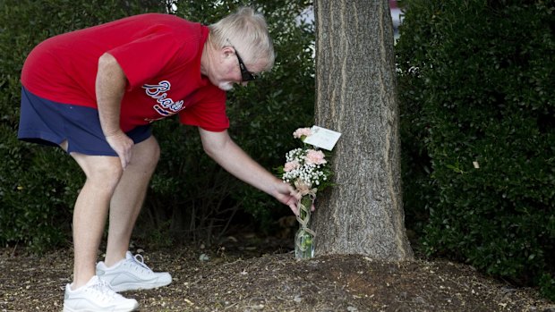 Rodney Booth delivers flowers to WDBJ's Digital Broadcast Centre, in Roanoke, Virginia, after hearing news of the fatal shooting of two of the station's journalists earlier in the day.