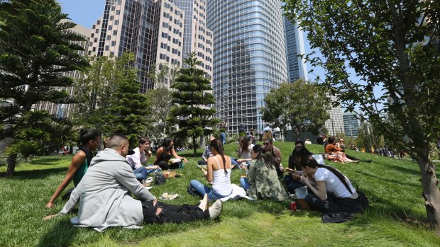 Workers have a picnic lunch on the rooftop park of the new Transbay Transit Center in San Francisco. 