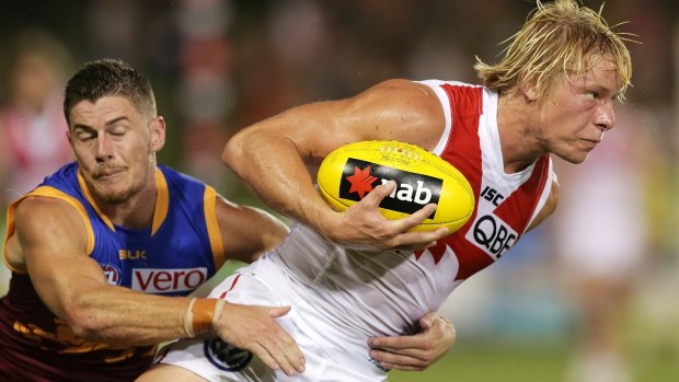 Caught: Swan Isaac Heeney is tackled during the clash with Brisbane. 