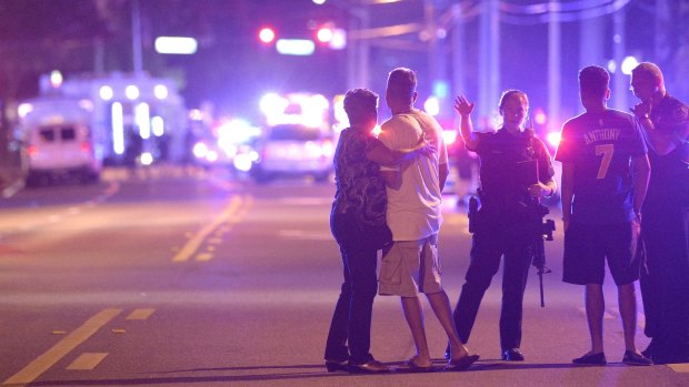 Orlando Police officers direct people away from a multiple shooting at the nightclub.  