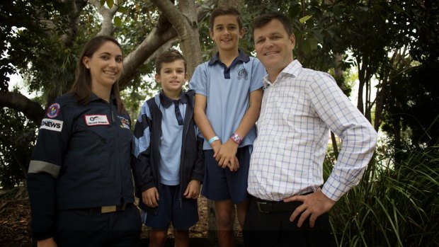 Westpac Lifesaver Rescue Helicopter crew member Gillian Howard is reunited with local dad Mark Anning and his two sons Henry, aged 8, and Joe, aged 10.