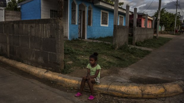 A girl in front of her family's home in a neighbourhood where homes were built by the government as part of the Houses for the people program in Managua.