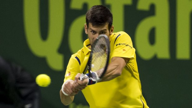 Victorious: Novak Djokovic plays a backhand shot to Rafael Nadal.