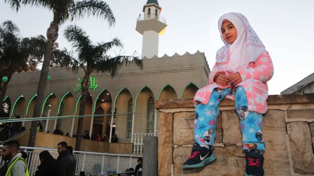 A girl sits in front of Lakemba Mosque during Eid al-Fitr. 