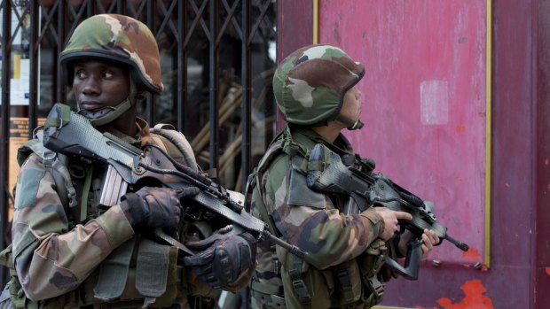 French soldiers take up position in Paris suburb Saint-Denis on Wednesday.