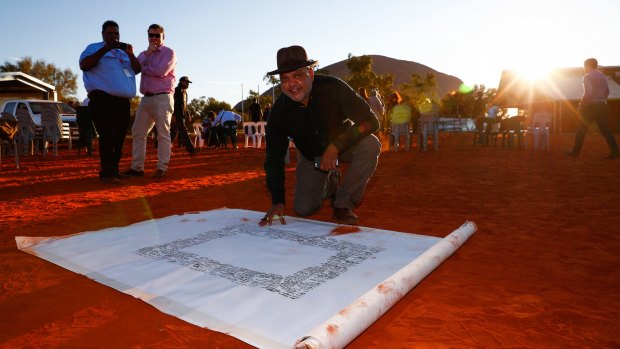 The Uluru Statement - the signing of which by Noel Pearson is shown here - called for a move to a national treaty.