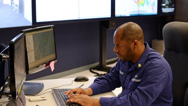 Petty Officer 1st Class Antonio Lockhart, at Coast Guard 7th District Command Centre, updating search information regarding the missing cargo ship El Faro.