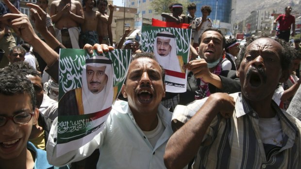 Anti-Houthi protesters in Taiz, Yemen, hold posters of Saudi King Salman bin Abdulaziz al-Saud on Sunday.
