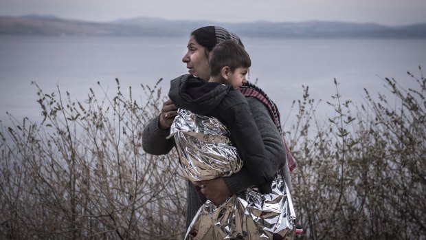A migrant woman and child, wrapped in an emergency blanket, on Lesbos island in Greece earlier this month. 