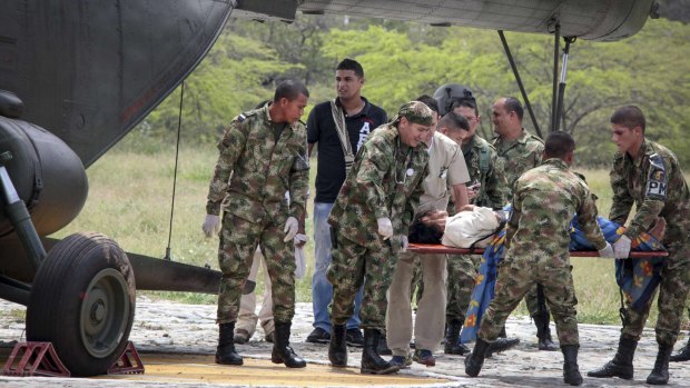 An injured lightning strike victim is moved from a helicopter at an army base in Santa Marta.