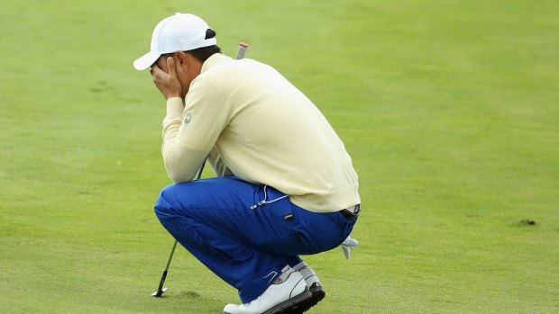 Bae Sang-moon of the International team reacts after making a poor pitch shot on the 18h hole.