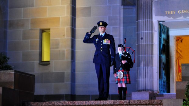 Squadron Leader Marcus Watson during the Last Post ceremony at the Australian War Memorial in Canberra for Flight Lieutenant John Napier Bell. 