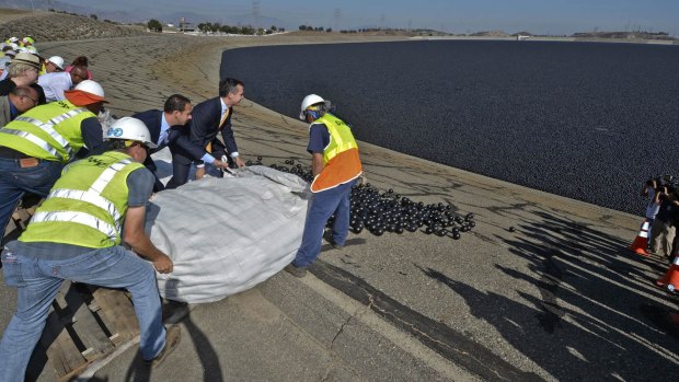 Los Angeles Mayor Eric Garcetti and LADWP workers deposit the final batch of over 90 million "shade balls" into the Los Angeles Reservoir.