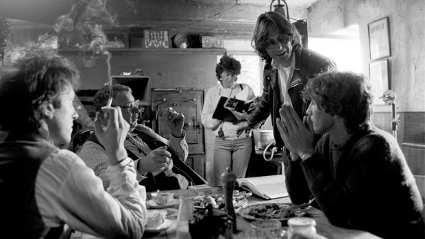 From left, Richard E. Grant, Richard Griffiths, Bruce Robinson (standing) and Paul McGann on the set of <i>Withnail & I</i>. 