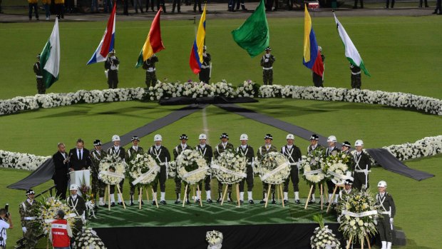 Soldiers and police attend a tribute to members of Brazil's Chapecoense soccer team who died in a plane crash, at the stadium where they were to play a game in Medellin, Colombia.