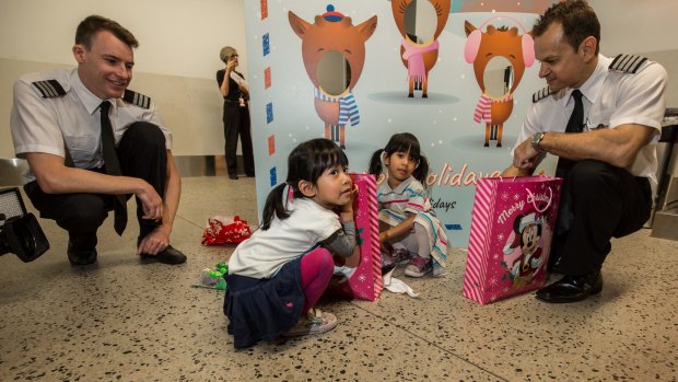 'Tis the season: On Friday, Jetstar pilots Jetstar pilots Captain Michael Santa and First Officer Jonathan Rudolph (yes, those are their real names) surprised kids on board their flight from Melbourne to Cairns with presents.