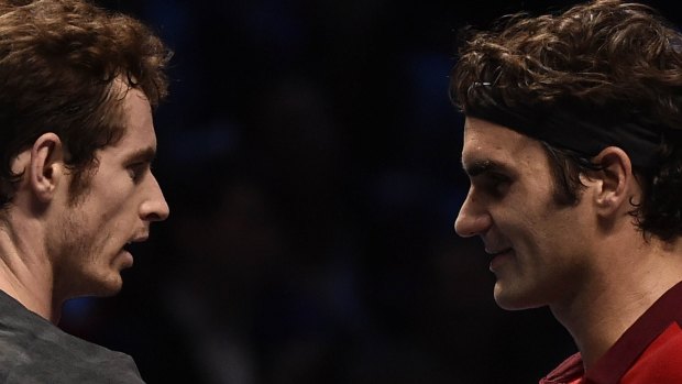 Roger Federer and Andy Murray meet at the net post-match.