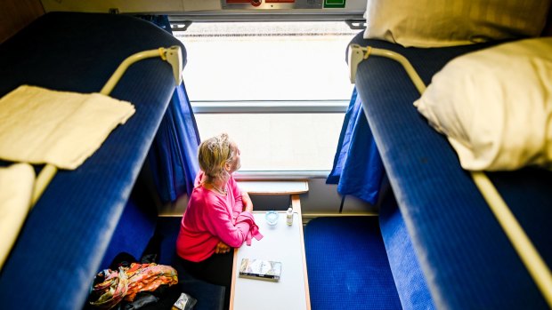 A woman travels in a compartment of a night express train in Westerland, Germany. 