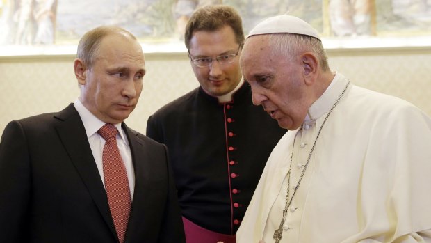 Russian President Vladimir Putin (left) listens to Pope Francis at the Vatican.