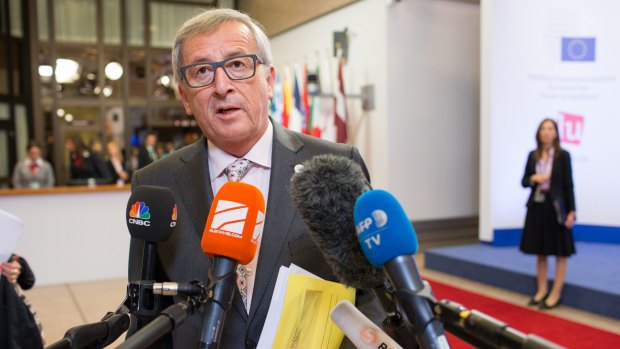 Jean-Claude Juncker, president of the European Commission, speaks with journalists following all-night Greece bailout talks in Brussels, Belgium.