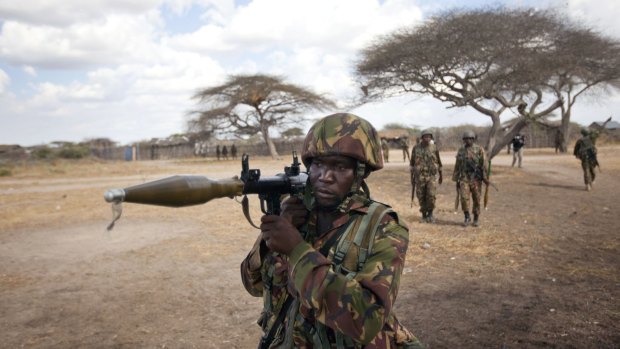 A Kenyan army soldier carries a rocket-propelled grenade launcher as he patrols Tabda, Somalia. 