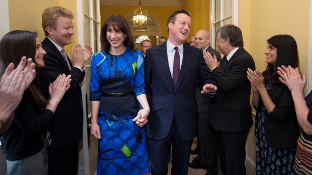 Britain's Prime Minister David Cameron and his wife Samantha applauded by staff upon entering 10 Downing Street after his election victory.