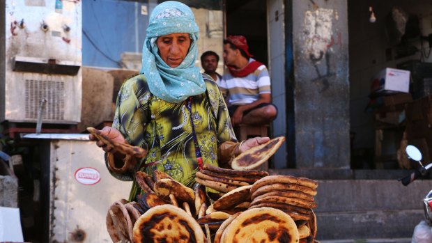 Marriam travels from Sabir Mountain to the city centre of Taiz to sell bread and earn an income. Her grandchildren are reliant on her income after their parents died.