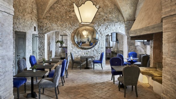 Contemporary furnishings in cool blues and greys throw the ancient stone walls and floors into sharp relief.