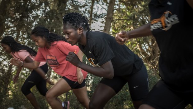 Eighteen-year-old South Sudanese asylum seeker Esteer Gabriel, second from right, prepares to sprint at a sports camp in northern Israel.