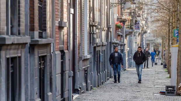 Men walk in the Rue Henri Berge in the Schaerbeek neighborhood of Brussels on Friday. A Brussels apartment in the Rue Henri Berge was likely used to make bombs for the Paris attacks, and one of the plotters also hid out there after escaping a police dragnet, Belgian prosecutors said Friday. 