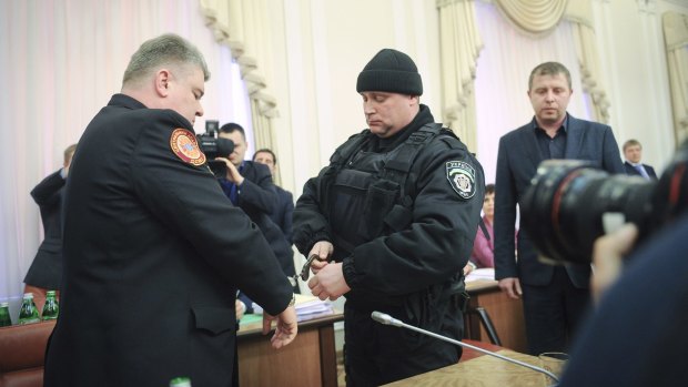 The chief of Ukraine's Emergency Services Ministry, Sergiy Bochkovsky, is handcuffed during a cabinet session in Kiev. 