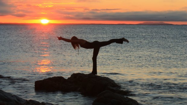 Mel Thomsom from Vitality Fitness doing beach yoga.
