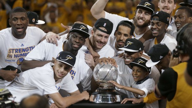 The Golden State Warriors celebrate after winning the western conference finals.