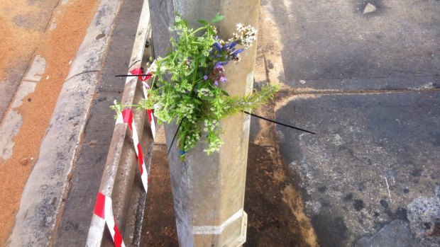 Flowers adorned the pole where the Aldi came to rest.