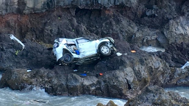 The vehicle sits at the bottom of a cliff off Maui's Hana Highway.