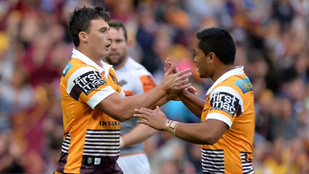 Lachlan Maranta of the Broncos celebrates with teammate Anthony Milford after scoring a try against Wests Tigers.